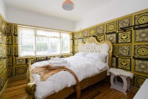 a bedroom with a large bed with ornate wallpaper at Luxury 2 King Bed Studio Apartment Hot Tub Sky Tv in Saffron Walden