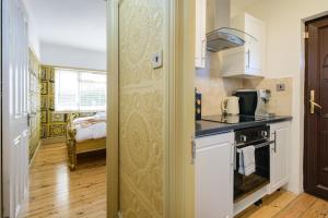 a kitchen with a sink and a stove at Luxury 2 King Bed Studio Apartment Hot Tub Sky Tv in Saffron Walden