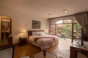 Postel nebo postele na pokoji v ubytování La Hostería Boutique Hotel