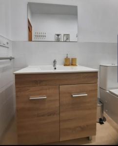 a kitchen with a sink and a refrigerator at TRANQUILO APARTAMENTO ZONA CENTRO in Alcalá de Guadaira