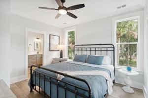 a bedroom with a bed and a ceiling fan at Champagne and Sunsets in Edisto Island