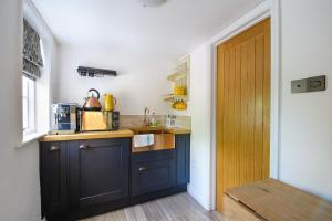 a kitchen with a blue island in a room at Beautiful 1-Bed Studio in Saffron Walden in Saffron Walden