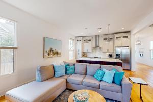 a living room with a couch and a kitchen at Pensacola Blue in Pensacola