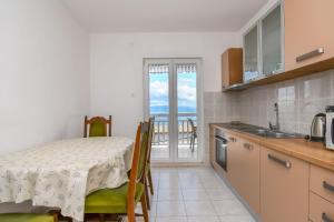 cocina con mesa y comedor con vistas en Apartments Vinka en Trogir