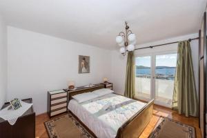 a bedroom with a bed and a large window at Apartment Ante in Vodice