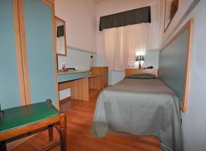Säng eller sängar i ett rum på Hotel Elisa