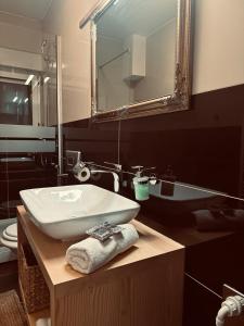 a bathroom with a sink and a mirror at Villa AYA - with sauna and outdoor swimming pool in Mostar