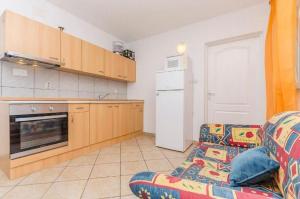 a living room with a couch and a kitchen at Apartments Mira in Starigrad