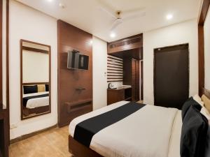 a hotel room with a bed and a tv at Collection O SRD Resort in Goa