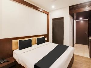 a bedroom with a large bed in a room at Collection O SRD Resort in Goa