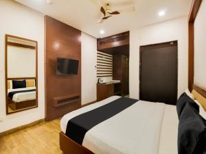 a hotel room with a bed and a tv at Collection O SRD Resort in Goa