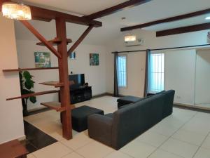 a living room with a couch and a table at Beach Road Oasis in Takoradi