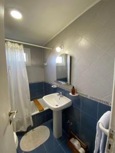 a blue bathroom with a sink and a mirror at Pichincha Bariloche DAT in San Carlos de Bariloche +12 photos