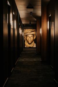 a hallway with a painting of a head on the wall at NeroHome Bed&Breakfast in Łomża