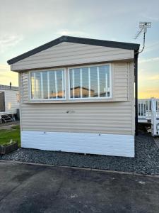 a garage with a large window on the side of it at 3 bed Stunning caravan situated nr Whitstable in Whitstable