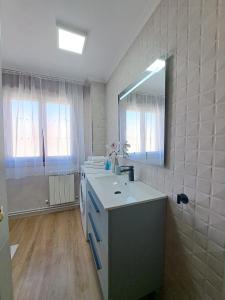 a bathroom with a sink and a mirror at Mi casita del norte in Mogro