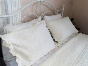 a white bed with two pillows on it at Bed & Breakfast private room and bath in Elkhart