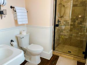 a bathroom with a toilet and a glass shower at Bed & Breakfast private room and bath in Elkhart