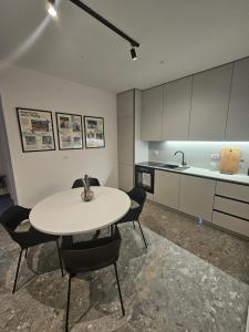 a kitchen with a table and chairs in a room at Adventure Oasis Bovec in Bovec