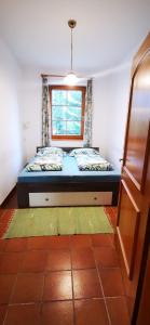 a small bedroom with a bed and a window at Haus Annaburg in Mariazell