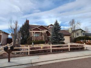 a house with a wooden fence in front of it at Colorado Cottage W/Mountain View in Colorado Springs