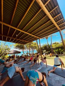 a group of people doing yoga on the beach at CASA VIDASURF in Pipa
