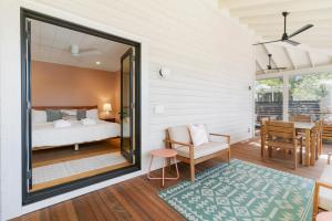 a bedroom with a bed and a dining room at 1st Block E Hudson - Green Wave - Newly Remodeled - Pool and Hot Tub - Ideal Central Location in Folly Beach +51 photos