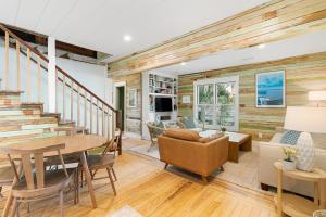 a living room with a wooden wall at 1st Block E Hudson - Green Wave - Newly Remodeled - Pool and Hot Tub - Ideal Central Location in Folly Beach