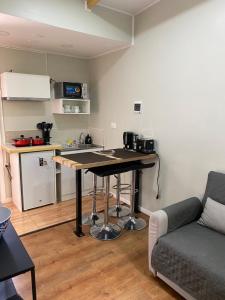 a kitchen with a table and a couch in a room at Cabañas Varas in Osorno