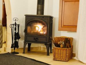 a black stove in a room with a basket at PETIT HOTEL ALGAIDA in Algaida