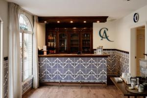 a kitchen with a counter with blue and white tiles at Casa Asturias in Ensenada