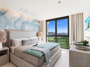 a bedroom with a bed and a large window at Fourteen at Mullet Bay in Cupecoy