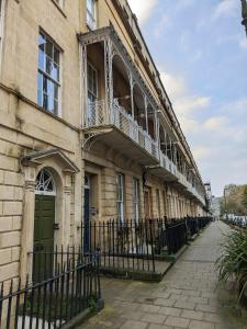 a building with a balcony on the side of it at Two Bedroom flat in Caledonia Place in Bristol