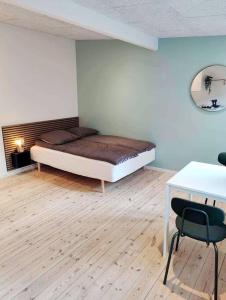 um quarto com uma cama, uma mesa e uma secretária em Charmerende bolig nær Domkirken em Ribe