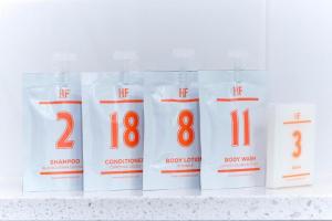 a row of white bleach bottles with numbers on them at Hotel Football, Old Trafford, a Tribute Portfolio Hotel in Manchester