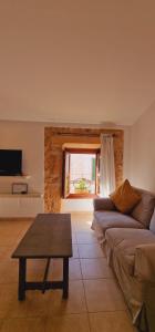 a living room with a couch and a table at PETIT HOTEL ALGAIDA in Algaida