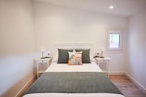 a bedroom with a large bed with two night stands at Villa Julia in Ribadavia