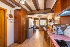 a kitchen with wooden cabinets and a counter top at CHALET EN MARBELLA, Casa Valle Iruelas in Marbella