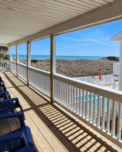 a porch with chairs and a view of the beach at The Savannah Inn in Carolina Beach