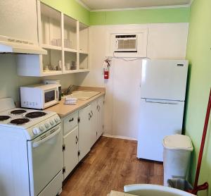 a kitchen with white appliances and a white refrigerator at The Savannah Inn in Carolina Beach