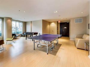 a room with a ping pong table and a couch at Spacious 1BR - Downtown - Pool - Gym - Parking in Toronto