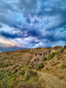 a dirt road on the side of a hill at Sonja's House of Sun, Bislim Gorge, Riverview & yard in Kumanovo