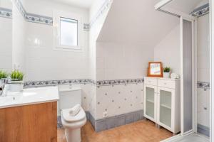 a bathroom with a toilet and a sink at Villa Sea Garden Holidays in Port d'Addaia +25 photos
