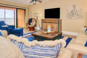 a living room with a tv and a couch at Reef Club 307 in Clearwater Beach