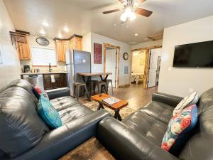 a living room with a leather couch and a table at Angel Rock Rentals of Moab Unit 5 in Moab