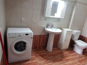 a bathroom with a washing machine and a sink at Kriopigi Apartments in Kriopigi +43 photos