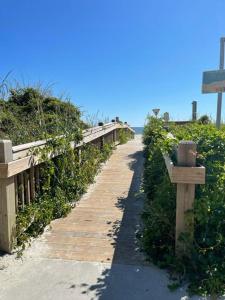 a path leading to the beach with a wooden fence at The Ocean Pearl in Myrtle Beach