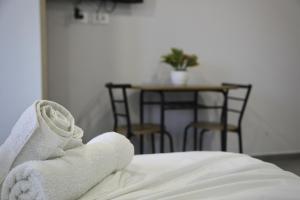 a close up of a bed with towels on it at Sea View Apartments in Golem