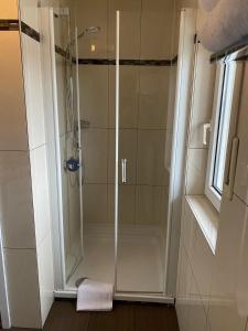 a shower with a glass door in a bathroom at Ferienwohnung Bornheim in Bornheim