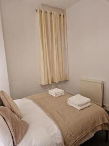 a bedroom with a bed with two towels on it at Shortridge Terrace - 2 in Jesmond